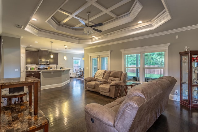 living room featuring coffered ceiling, a wealth of natural light, and ornamental molding