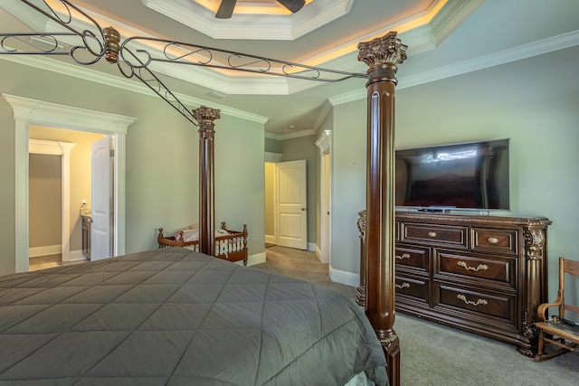 carpeted bedroom featuring a raised ceiling and crown molding