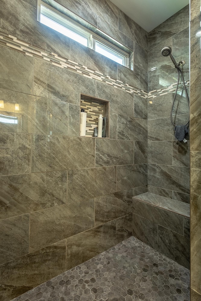 bathroom with a tile shower