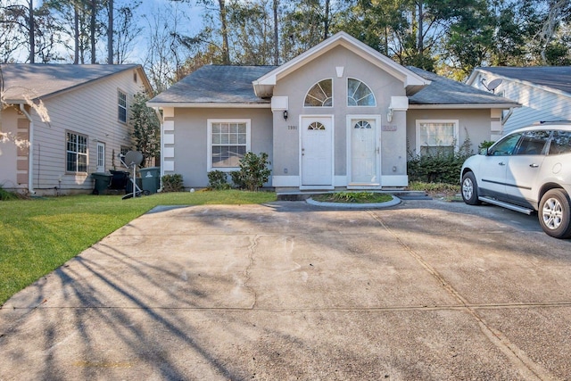 single story home featuring a front lawn