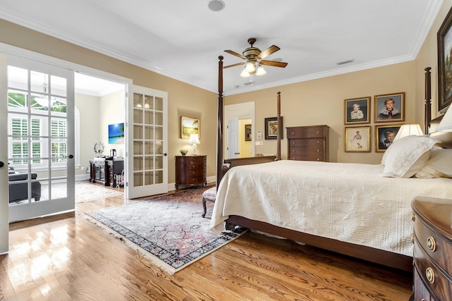 bedroom featuring crown molding, hardwood / wood-style floors, and french doors