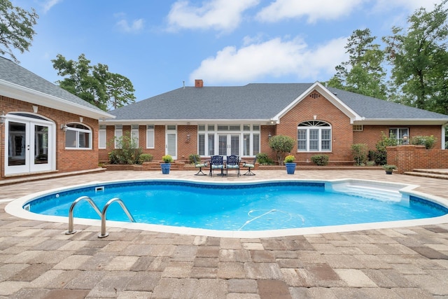 view of pool with a patio area and french doors