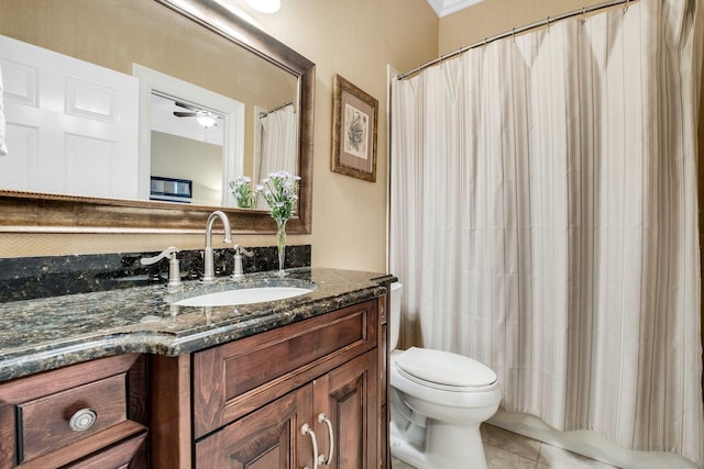 bathroom featuring toilet, vanity, curtained shower, ceiling fan, and tile patterned flooring