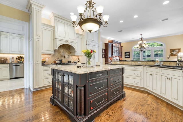 kitchen with sink, hanging light fixtures, dark brown cabinets, a notable chandelier, and stainless steel appliances