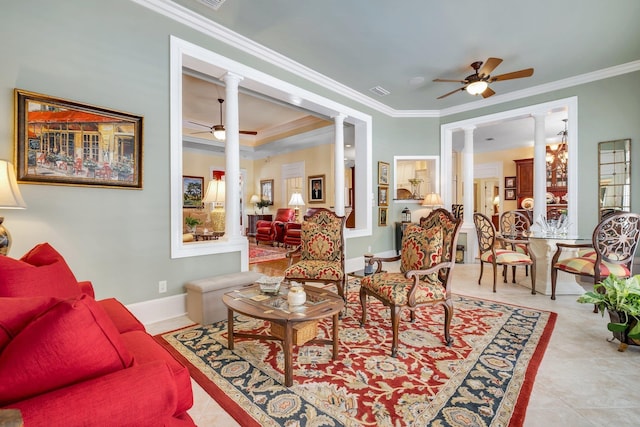 tiled living room with ceiling fan, ornamental molding, a tray ceiling, and decorative columns