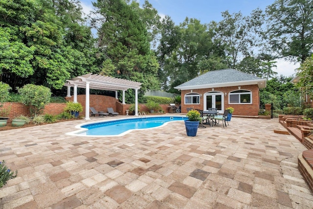 view of swimming pool with an outbuilding, a pergola, and a patio