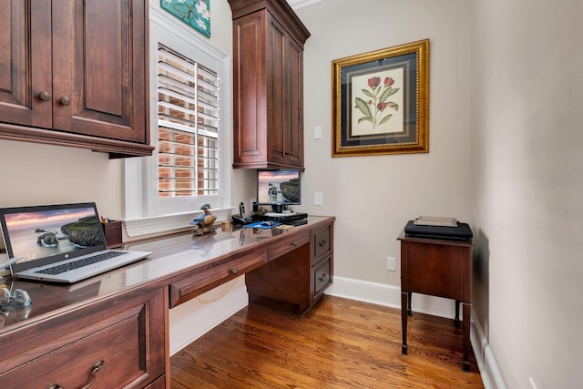 office with hardwood / wood-style floors and built in desk