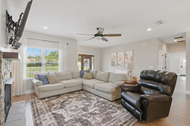 604 Judson Dr, Perry, FL 32348 - living room with light wood-type flooring, ceiling fan, a fireplace, baseboards, and recessed lighting