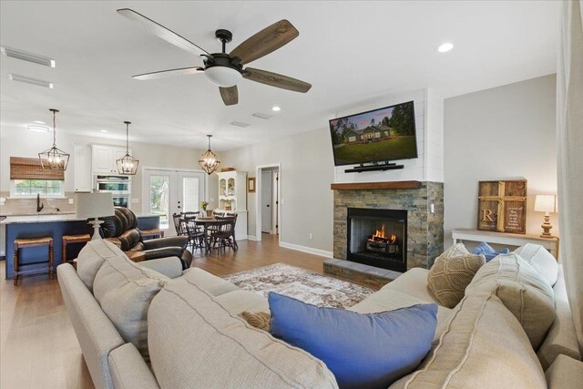 604 Judson Dr, Perry, FL 32348 - living area featuring a fireplace, recessed lighting, light wood-type flooring, ceiling fan, and baseboards