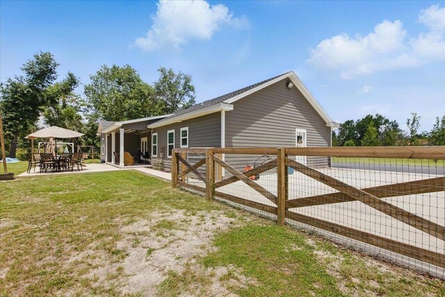 604 Judson Dr, Perry, FL 32348 - view of home's exterior featuring a patio area, ceiling fan, and outdoor dining space