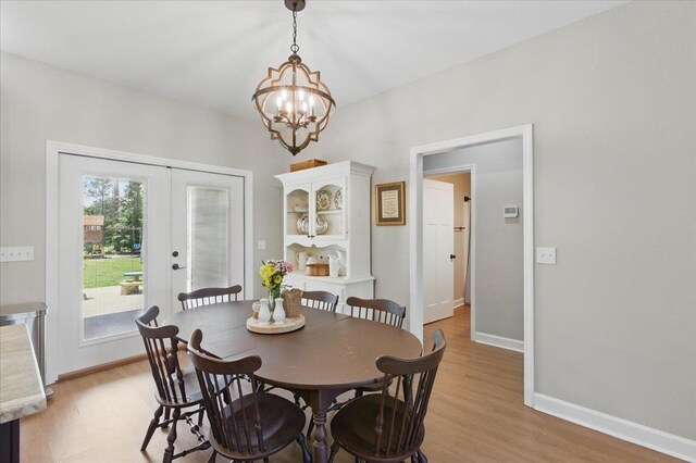 604 Judson Dr, Perry, FL 32348 - dining room featuring french doors, a chandelier, light wood-type flooring, and baseboards