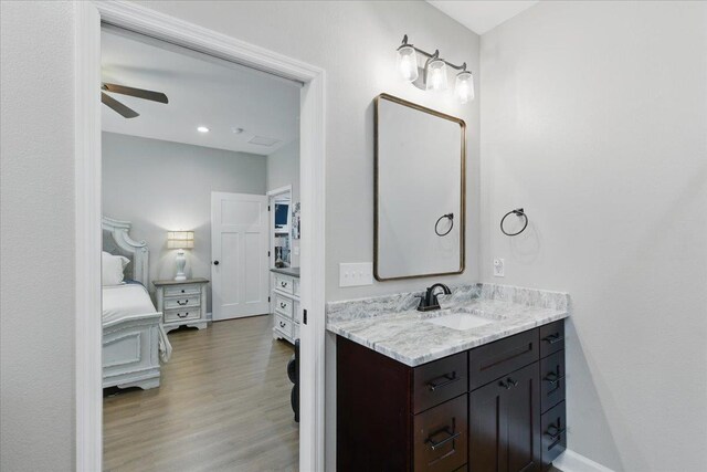 604 Judson Dr, Perry, FL 32348 - ensuite bathroom featuring vanity, wood finished floors, and a ceiling fan