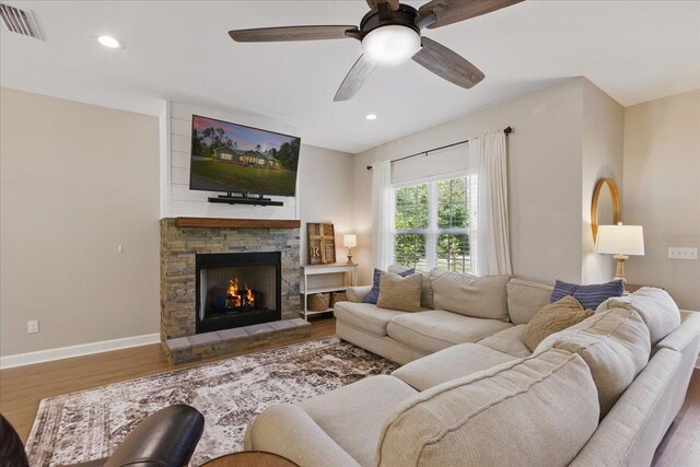 604 Judson Dr, Perry, FL 32348 - living room with wood finished floors, a ceiling fan, a stone fireplace, recessed lighting, and baseboards