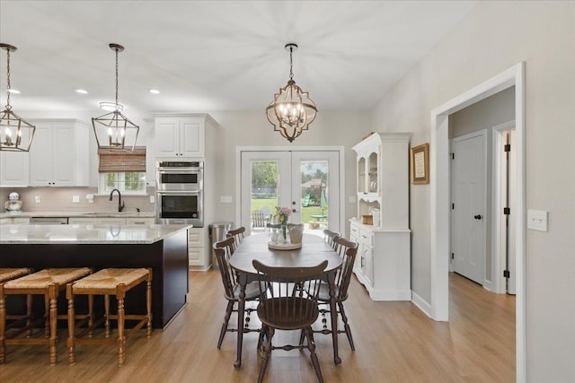 604 Judson Dr, Perry, FL 32348 - dining space with a chandelier, french doors, light wood-style floors, and recessed lighting