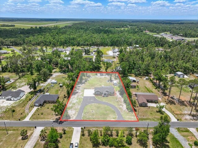 604 Judson Dr, Perry, FL 32348 - aerial view of residential area featuring property boundaries highlighted and a heavily wooded area