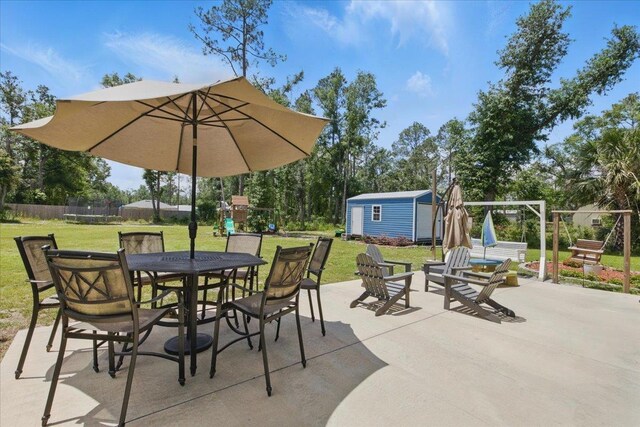 604 Judson Dr, Perry, FL 32348 - view of patio featuring a playground, a trampoline, and outdoor dining area
