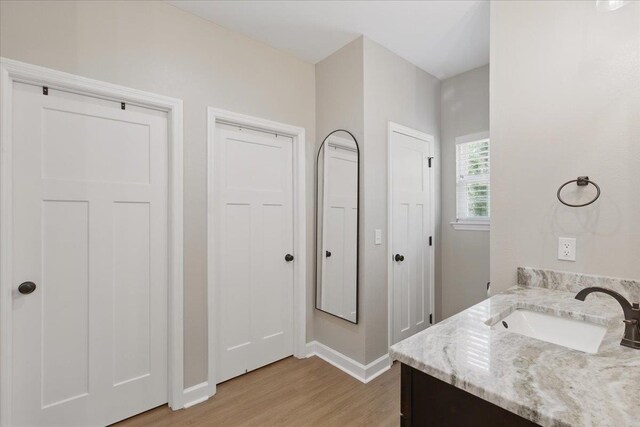 604 Judson Dr, Perry, FL 32348 - bathroom featuring wood finished floors, baseboards, and vanity