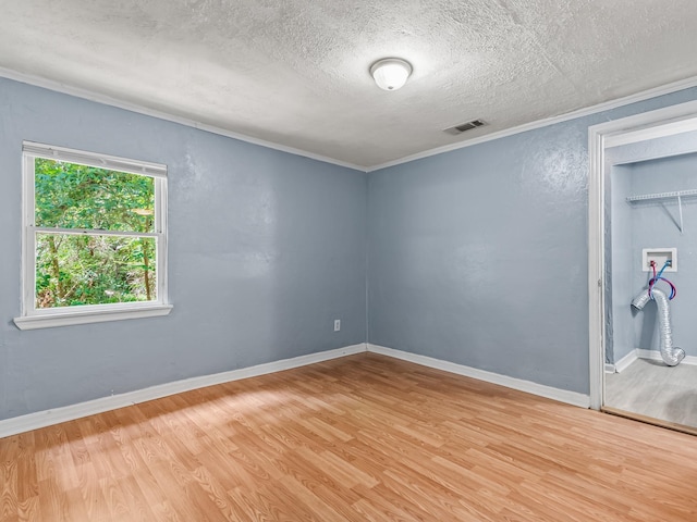 1487 Bainbridge Hwy, Quincy, FL 32352 - empty room featuring light wood finished floors, a textured ceiling, and crown molding