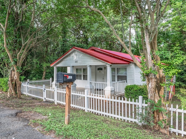 1487 Bainbridge Hwy, Quincy, FL 32352 - bungalow-style home with a porch, a metal roof, and a fenced front yard