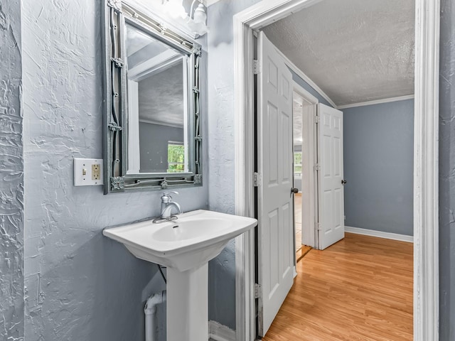 1487 Bainbridge Hwy, Quincy, FL 32352 - bathroom featuring wood finished floors, a textured ceiling, crown molding, and a textured wall