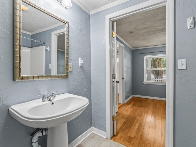 1487 Bainbridge Hwy, Quincy, FL 32352 - bathroom with wood finished floors, ornamental molding, and a textured wall