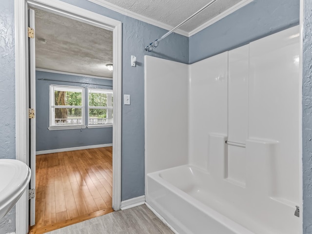 1487 Bainbridge Hwy, Quincy, FL 32352 - full bath featuring crown molding, wood finished floors, shower / tub combination, and a textured ceiling