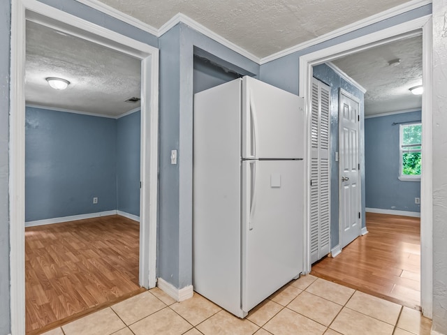1487 Bainbridge Hwy, Quincy, FL 32352 - kitchen with freestanding refrigerator, a textured ceiling, crown molding, and light wood-type flooring
