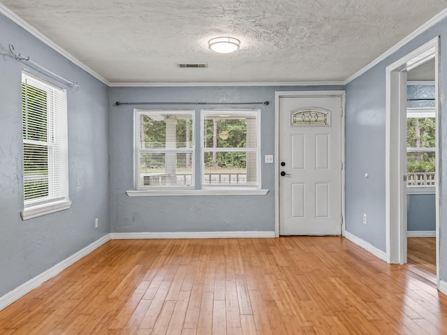 1487 Bainbridge Hwy, Quincy, FL 32352 - entryway with light wood-style flooring, healthy amount of natural light, crown molding, and a textured ceiling