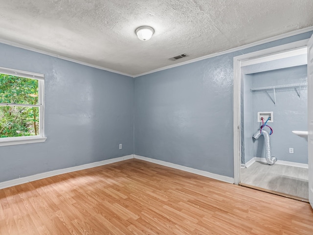 1487 Bainbridge Hwy, Quincy, FL 32352 - empty room featuring a textured ceiling, wood finished floors, and ornamental molding