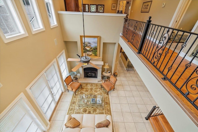 tiled living room featuring ceiling fan