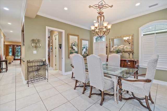 dining space with an inviting chandelier, crown molding, and light tile patterned flooring