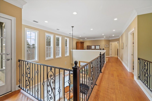 hallway featuring crown molding and light hardwood / wood-style flooring