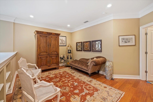 living room featuring crown molding and light hardwood / wood-style floors