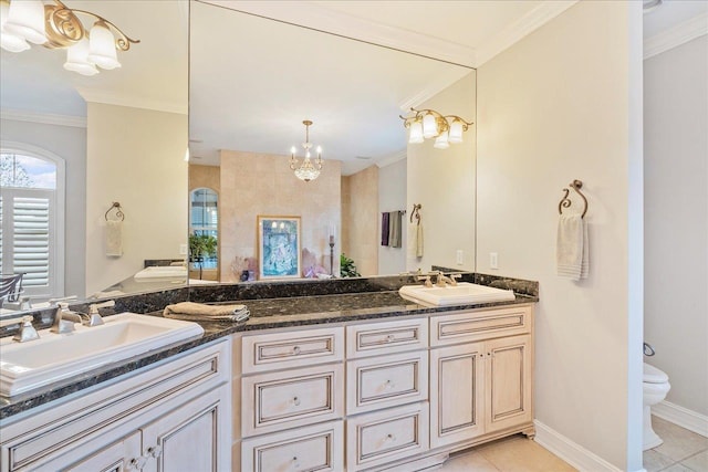 bathroom with tile patterned flooring, ornamental molding, vanity, a notable chandelier, and toilet