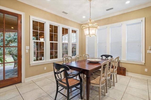 dining room featuring light tile patterned floors, crown molding, and a wealth of natural light