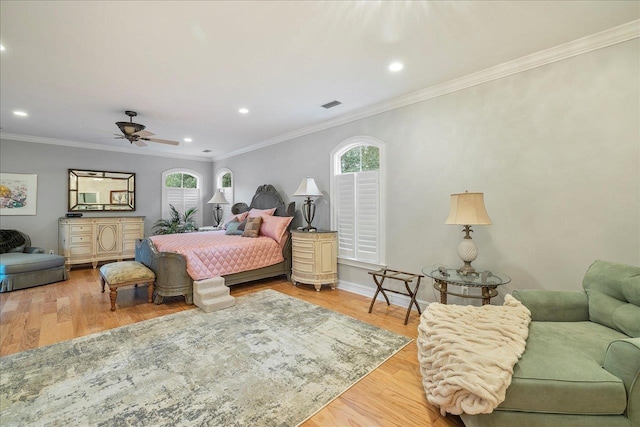 bedroom featuring multiple windows, crown molding, light hardwood / wood-style floors, and ceiling fan