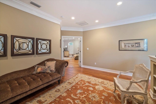 living room featuring crown molding and light hardwood / wood-style floors