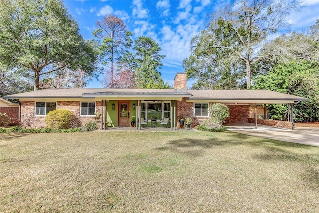 ranch-style home featuring concrete driveway, brick siding, a chimney, and a front lawn