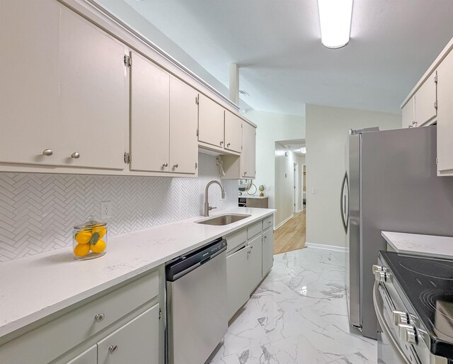 804 Medical Commons Ct, Tallahassee, FL 32310 - kitchen with appliances with stainless steel finishes, a sink, tasteful backsplash, light countertops, and light marble finish flooring