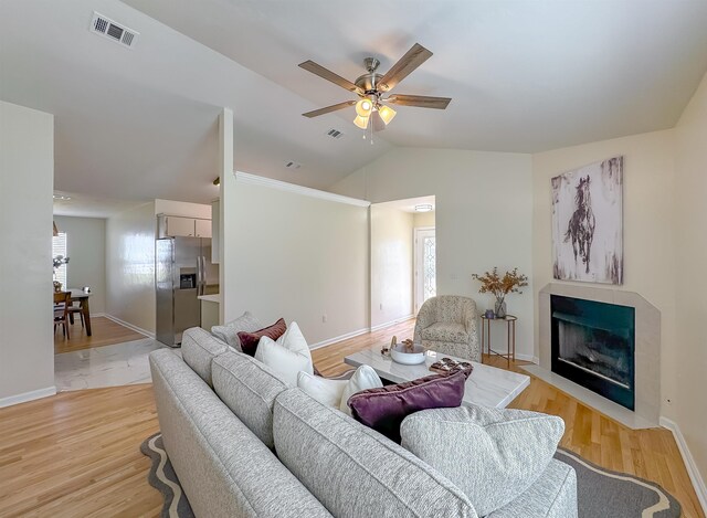 804 Medical Commons Ct, Tallahassee, FL 32310 - living room with plenty of natural light, vaulted ceiling, ceiling fan, light wood-style floors, and a fireplace with flush hearth