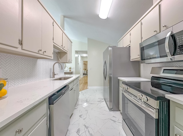 804 Medical Commons Ct, Tallahassee, FL 32310 - kitchen featuring stainless steel appliances, a sink, light marble finish flooring, light countertops, and tasteful backsplash