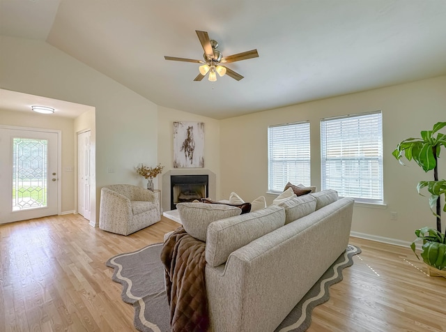 804 Medical Commons Ct, Tallahassee, FL 32310 - living room with lofted ceiling, light wood finished floors, a ceiling fan, baseboards, and a fireplace with raised hearth