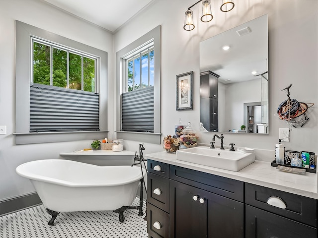 bathroom with vanity, tile patterned floors, and a bathtub