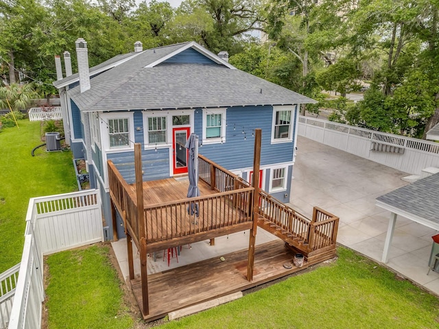 rear view of house featuring cooling unit, a yard, a deck, and a patio