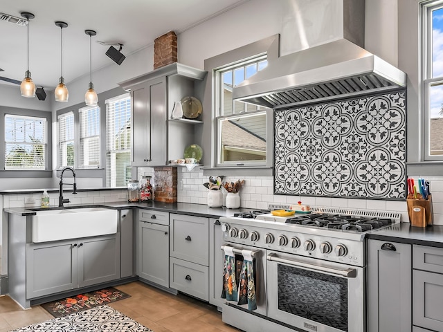 kitchen featuring sink, gray cabinets, range with two ovens, and island exhaust hood