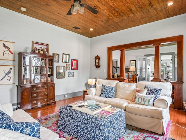 living room featuring hardwood / wood-style flooring, wooden ceiling, decorative columns, and ceiling fan