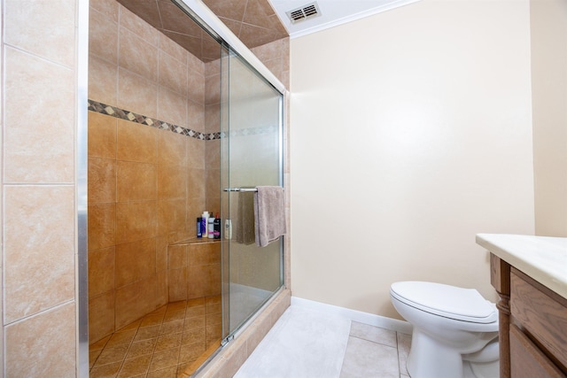 bathroom featuring toilet, tile patterned floors, a shower with door, and vanity