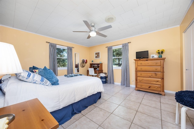 bedroom with ceiling fan, tile patterned floors, and ornamental molding