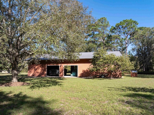 rear view of property featuring a lawn