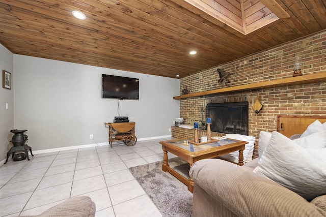 tiled living room with a skylight, a fireplace, brick wall, and wooden ceiling